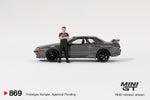 2025 MINI GT #869 Nissan Skyline GT-R (R32) Gunmetal W/ Matsuda Figure Tsugio Matsuda Collection