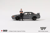 2025 MINI GT #869 Nissan Skyline GT-R (R32) Gunmetal W/ Matsuda Figure Tsugio Matsuda Collection
